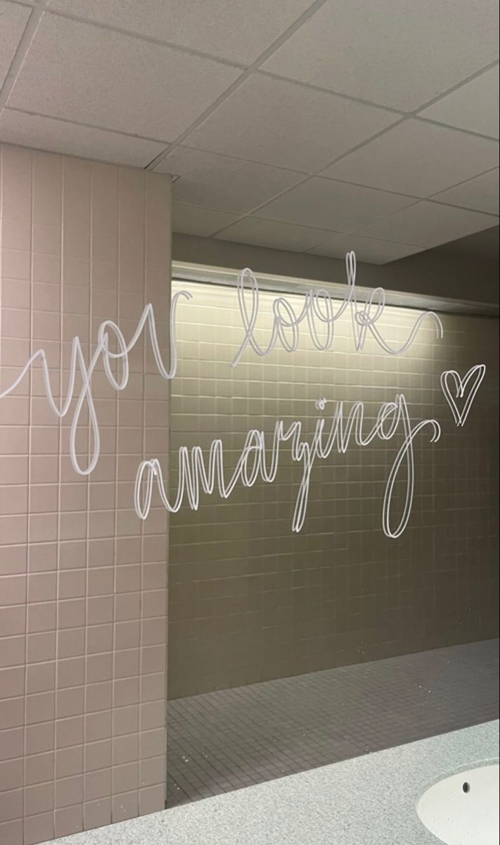 the bathroom is decorated with writing on the wall