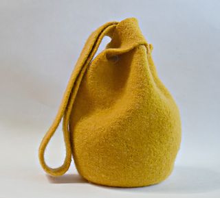 a yellow purse sitting on top of a white table