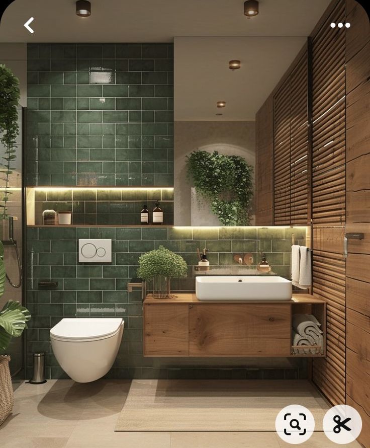 a bathroom with green tiles and wood accents, including a white toilet next to a sink