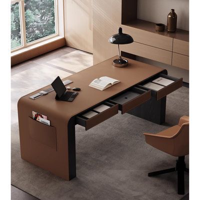 an office desk with a laptop on it