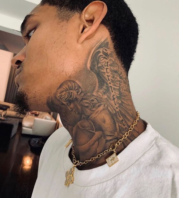 a man with a tattoo on his neck