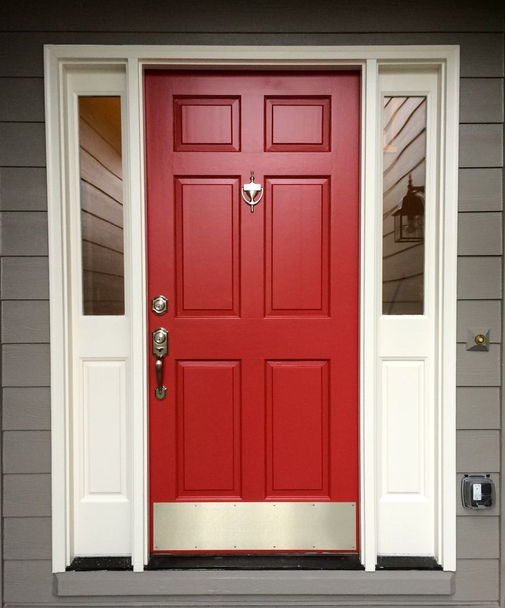 a red front door with two sidelights