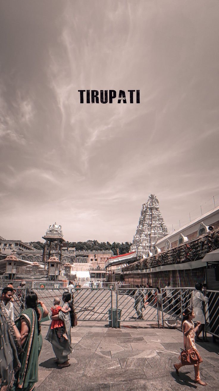 some people are walking around in front of a large structure with the word trupati above them