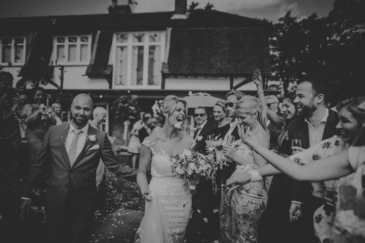 the bride and groom are surrounded by confetti as they walk down the aisle