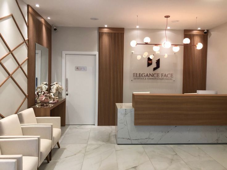 a reception area with white chairs and marble counter