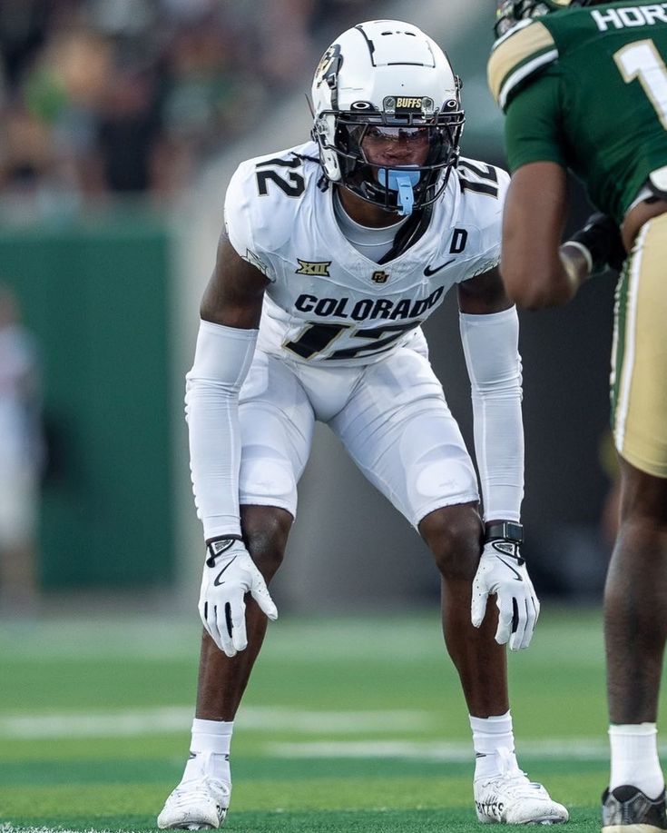 a football player standing on top of a field