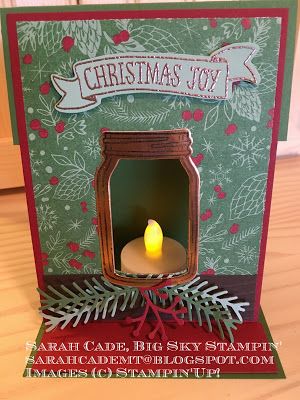 a christmas card with a lit candle inside