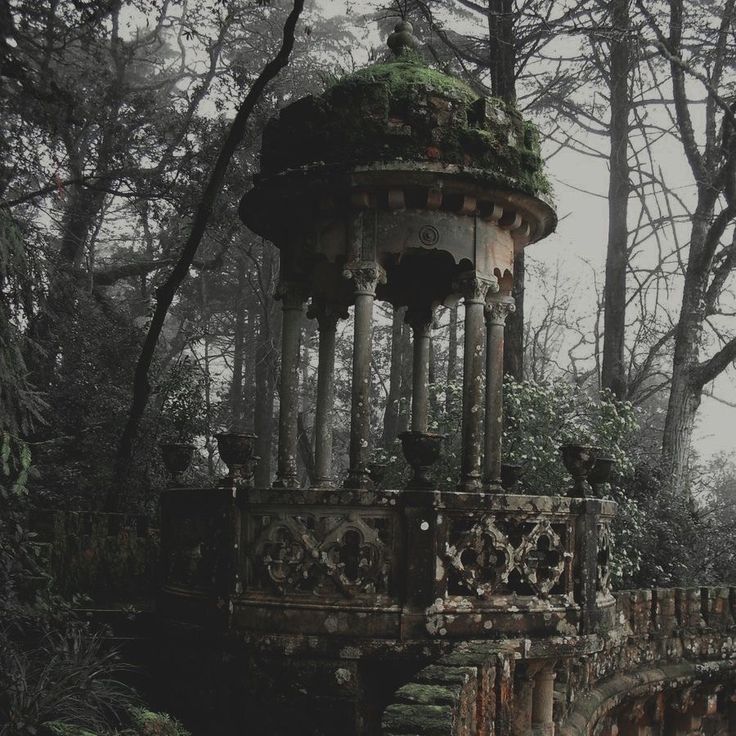 an old stone structure with moss growing on it