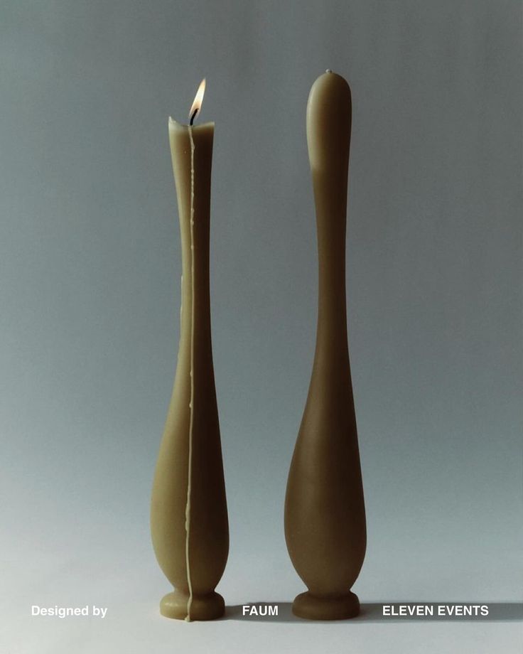 there are two candles in the shape of vases