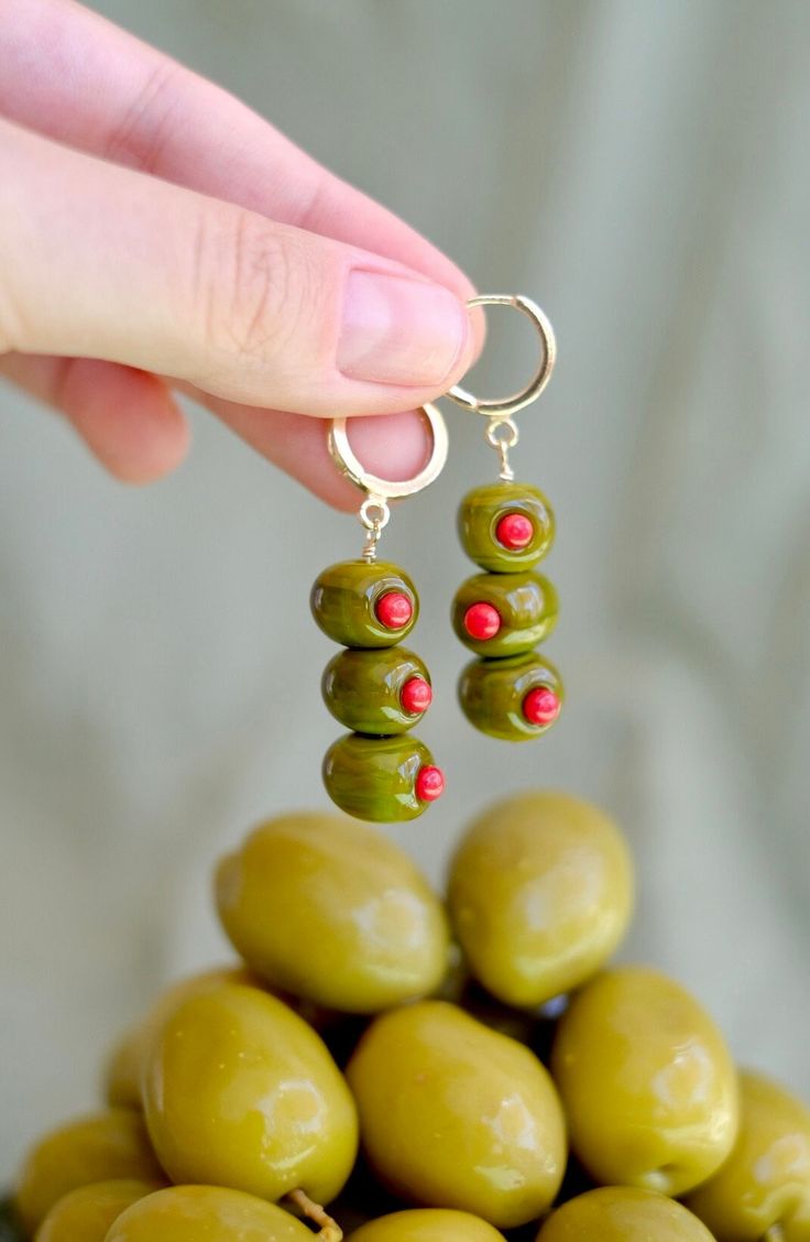 These handmade glass earrings, crafted in lampwork technique, are a playful nod to the iconic olive in a martini 🫒 Each earring features a delicate glass olive, complete with vibrant green hues and a red pimento center, capturing the essence of cocktail chic 🍸 Their unique design and attention to detail make them a stylish and standout accessory, perfect for adding a touch of whimsy to any outfit 🫒 Blown Glass Earrings, Artisan Multicolor Murano Glass Jewelry, Martini Olives, Handmade Vintage Murano Glass Jewelry, Murano Glass Earrings, Lampwork Earring, Style Expert, Glass Earrings, Murano Glass