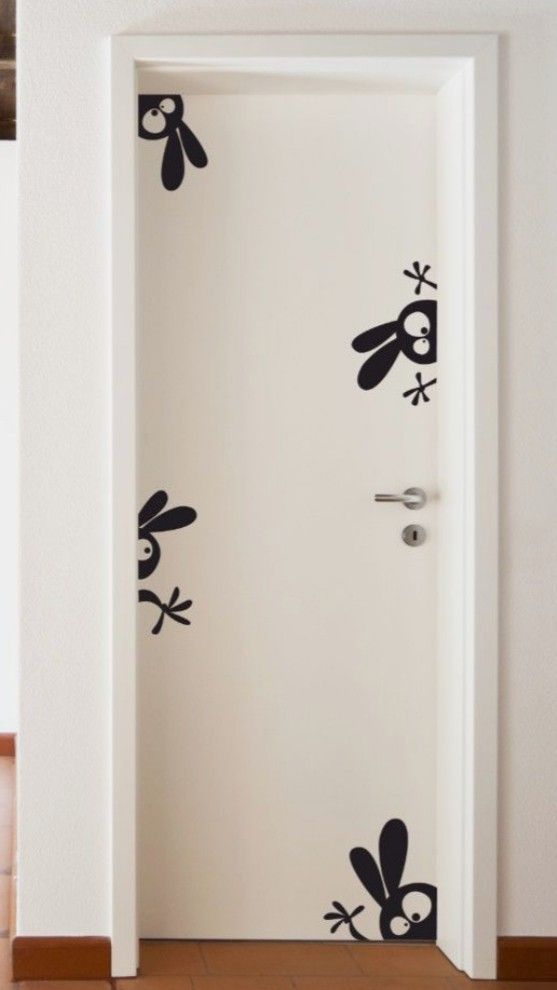 an open door with some black and white stickers on the doors side by side