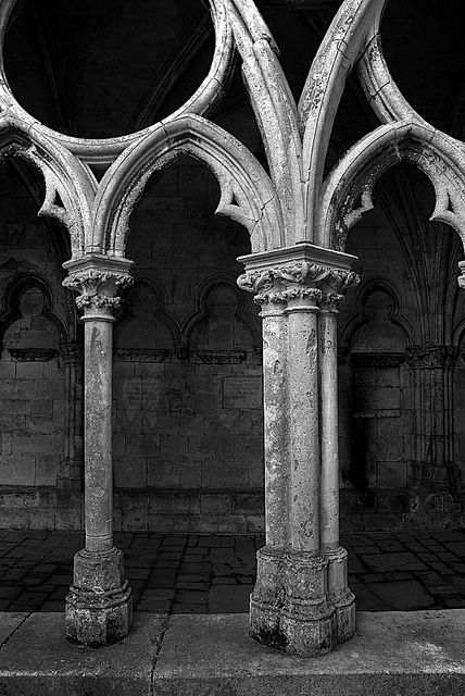 an old building with stone pillars and arches