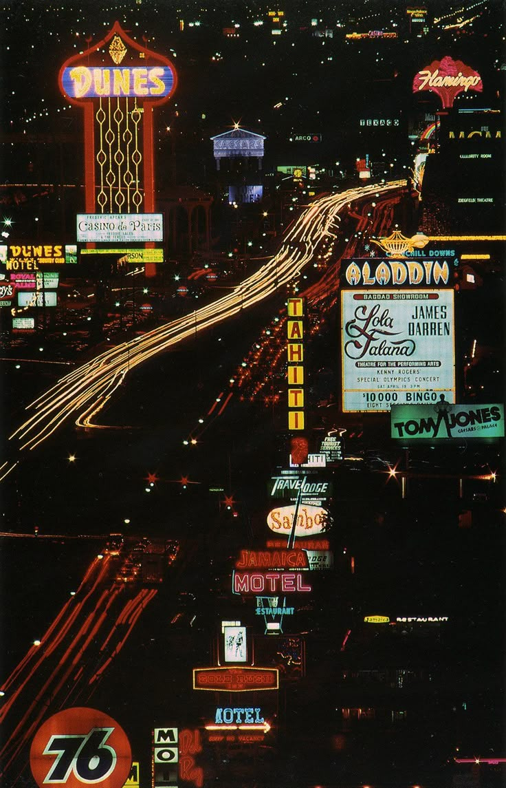 an aerial view of the las vegas strip at night with neon signs and buildings in the background