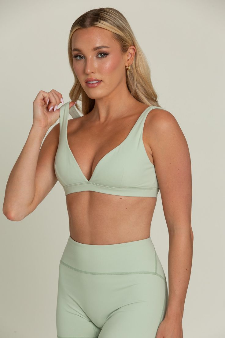 Our Pastel Green Bralette will be your go-to for everyday comfort. This plunging V-cut neckline bralette features removable padding for customizable support and is hardware-free for a seamless fit. Crafted from buttery soft fabric, it offers a luxurious feel against your skin. Perfect for lounging or layering, this comfortable and stylish bralette will quickly become a staple in your wardrobe. Chic Seamless Low-cut Bra, Seamless V-neck Yoga Bra, Seamless V-neck Bra For Yoga, Yoga Seamless V-neck Bra, V-neck Workout Bra With Built-in Support, Seamless Triangle Top Sports Bra, Low-cut Sports Bra With Removable Pads, Triangle Top Sports Bra With Removable Pads, Chic V-neck Swimwear That Is Bra Friendly