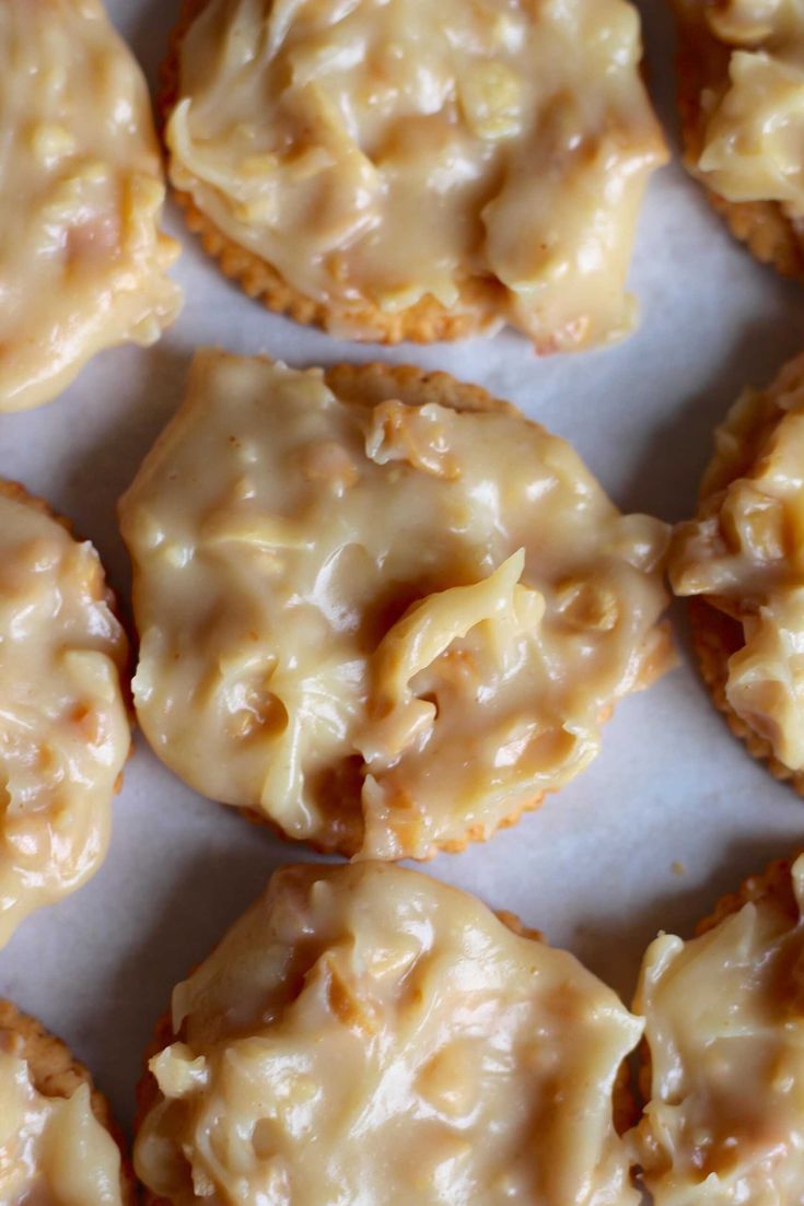 some cookies are covered with icing and sitting on a piece of parchmented paper