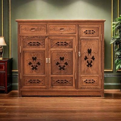 a large wooden cabinet sitting on top of a hard wood floor next to a lamp