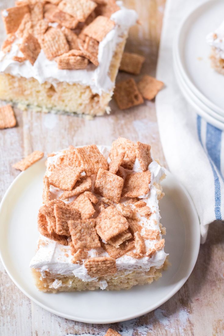 a piece of cake with marshmallows and whipped cream on top is sitting on a plate