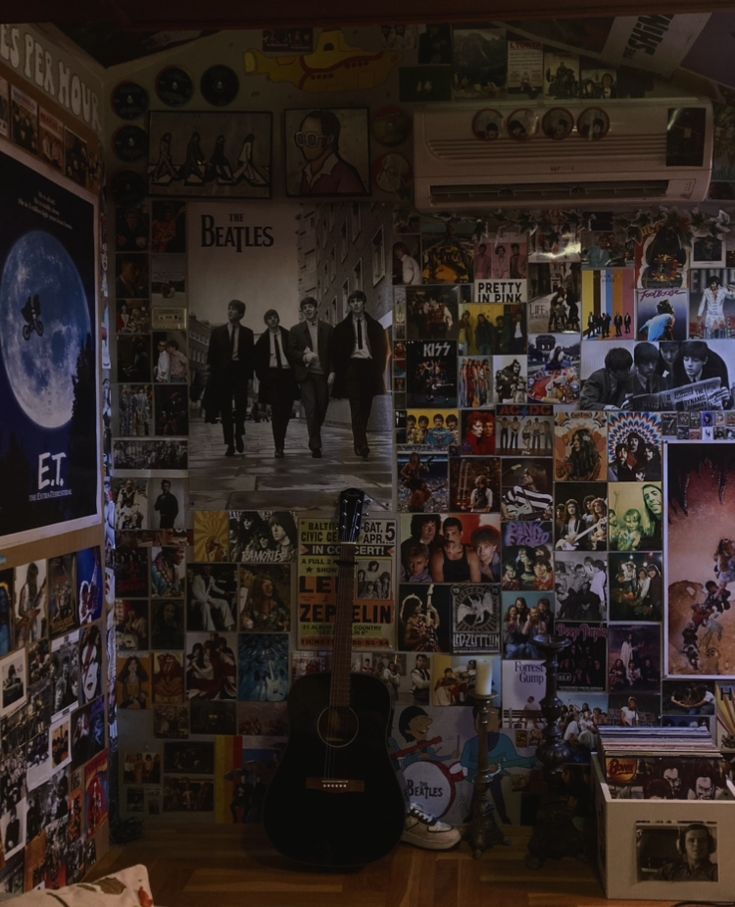 a room filled with lots of posters and guitars