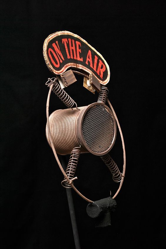 a metal sculpture with a sign on the air attached to it's back end