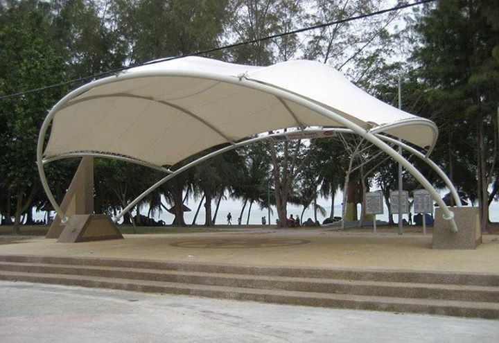 an outdoor covered area with steps and trees in the background