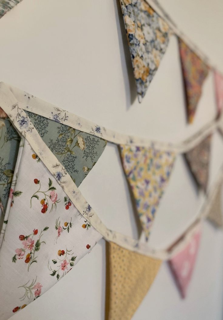 the bunting is hanging on the wall with many different colors and patterns in it