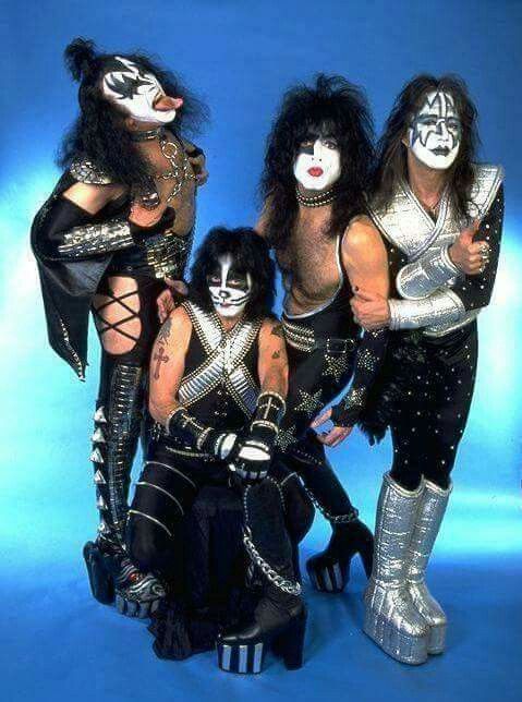 the kiss band is posing for a photo in their black and white makeup suits with silver accessories