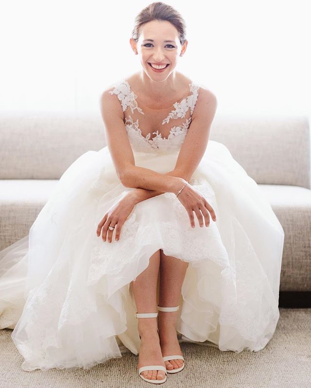 a woman in a wedding dress sitting on a couch