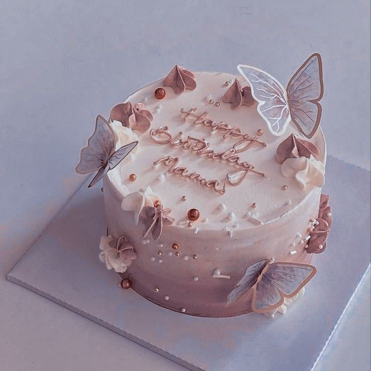 a birthday cake decorated with butterflies and frosting