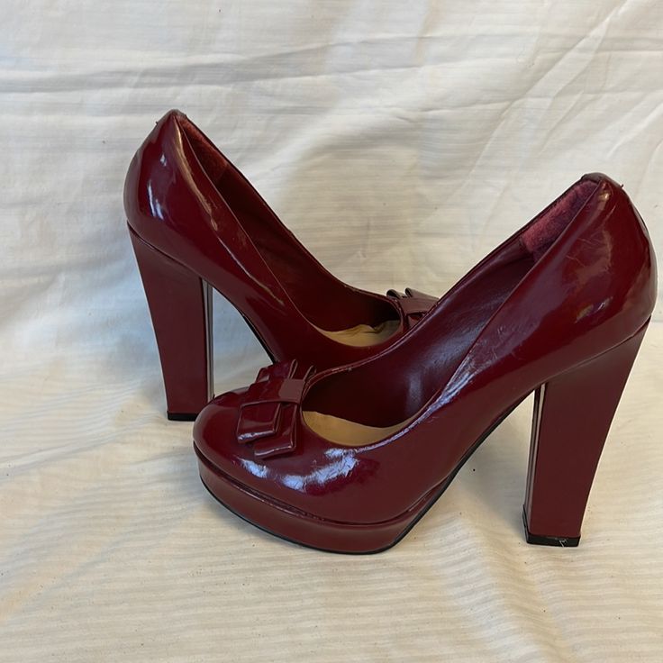 Pour La Victoire Pump Heels Size: 8 Color: Red Solid Round Toe With Bow Detail Sleek Patent Leather Upper Platform: 1" Heel High: 4" Pre-Owned , Store Displayed Item With Minor Peels Red Block Heel Court Shoes For Formal Occasions, Elegant Red Block Heel Court Shoes, Red Patent Leather Court Shoes With Block Heel, Red Patent Leather Court Shoes For Formal Occasions, Chic Burgundy Patent Leather Heels, Chic Formal Heels With Red Bow, Elegant Red Court Shoes With Round Toe, Red Formal Court Shoes With Padded Heel, Formal Red Round Toe Heels