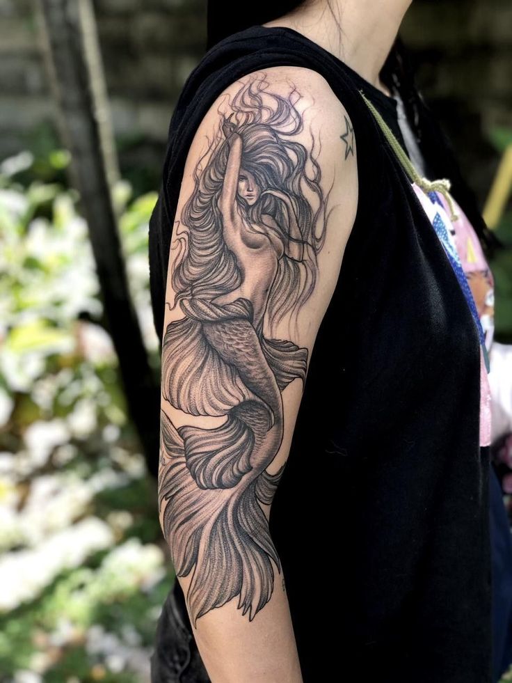 a woman with a tattoo on her arm