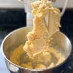 a metal bowl filled with batter on top of a counter