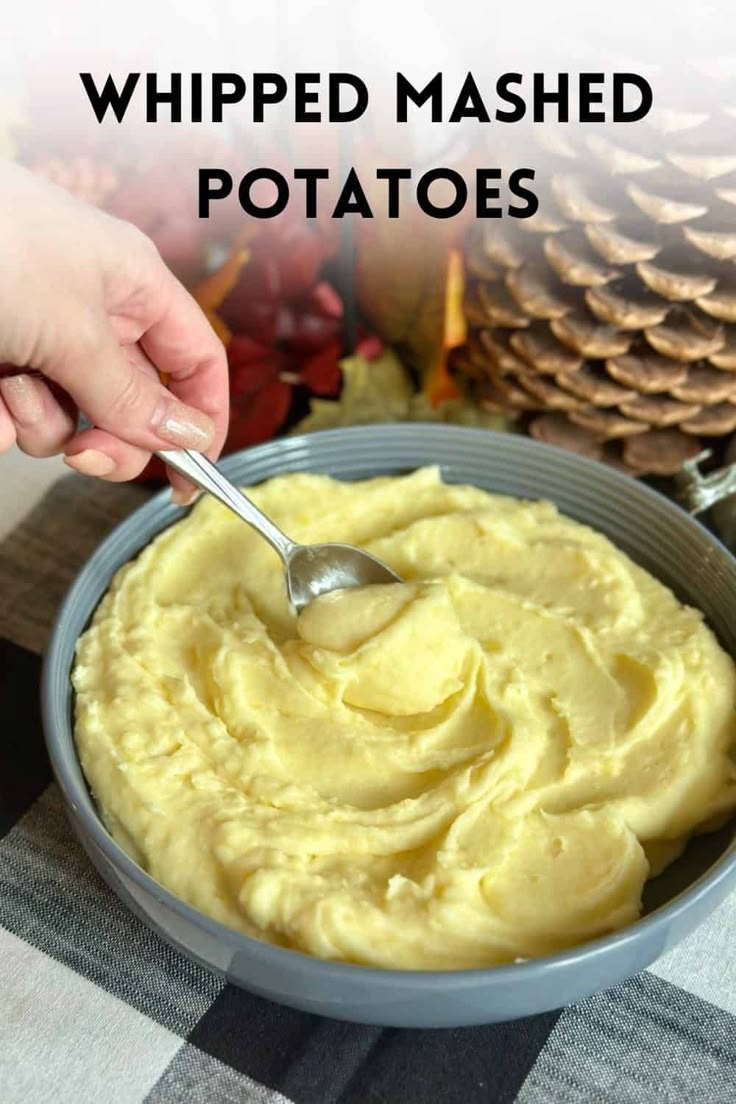 a person spooning mashed potatoes into a bowl