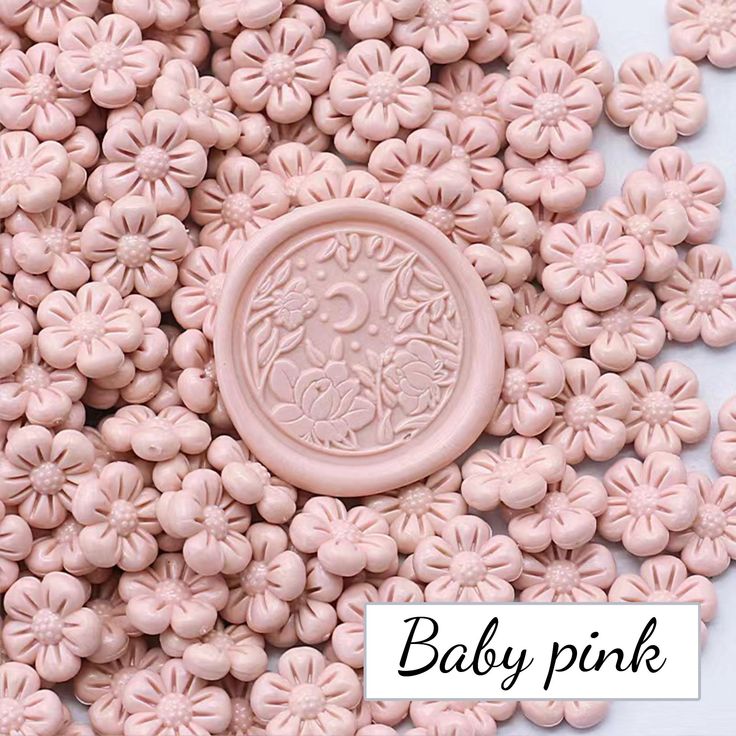 baby pink flower beads with a button in the middle on a white background that says, baby pink