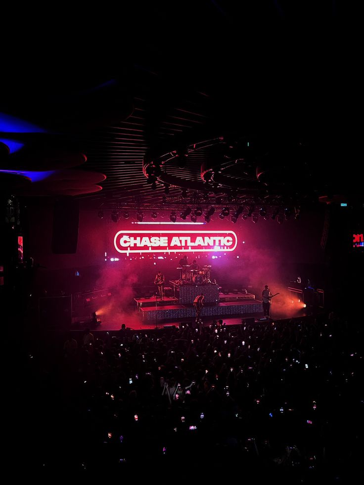 the stage is lit up with red and blue lights as it stands in front of an audience