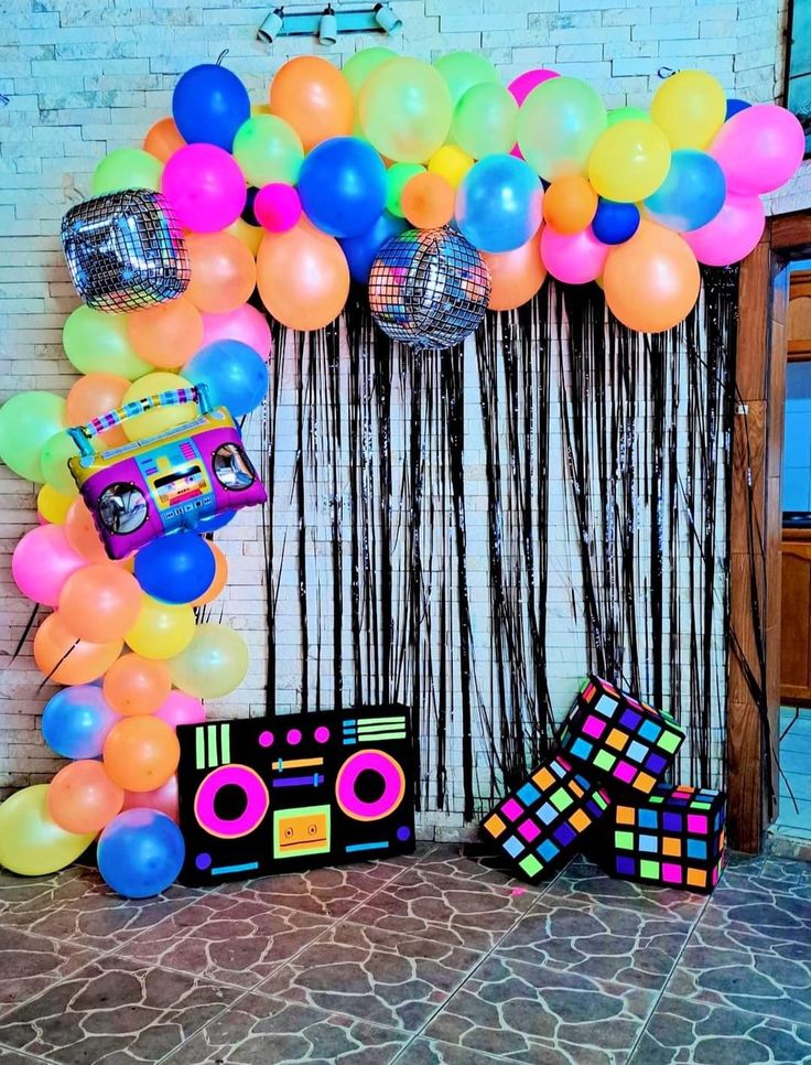 there is a party decoration with balloons and disco balls