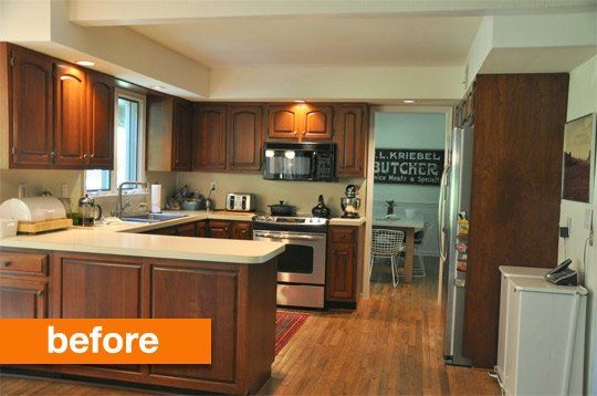 a kitchen with wooden cabinets and white counter tops is pictured in this image from the doorway to the living room