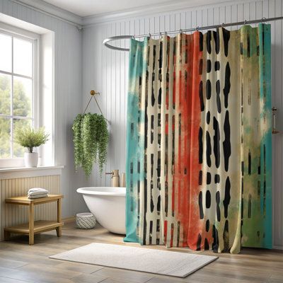 a bathroom with a shower curtain that has an abstract pattern on it and a bathtub in the background