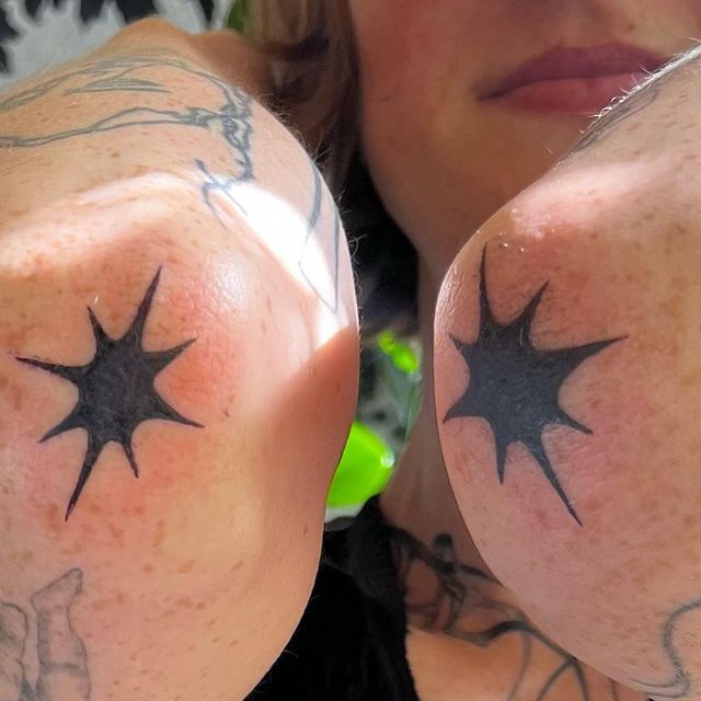 a woman with tattoos on her arms and shoulder