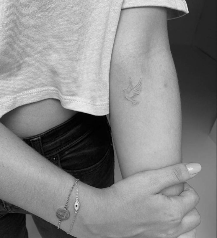 a woman with a small tattoo on her arm