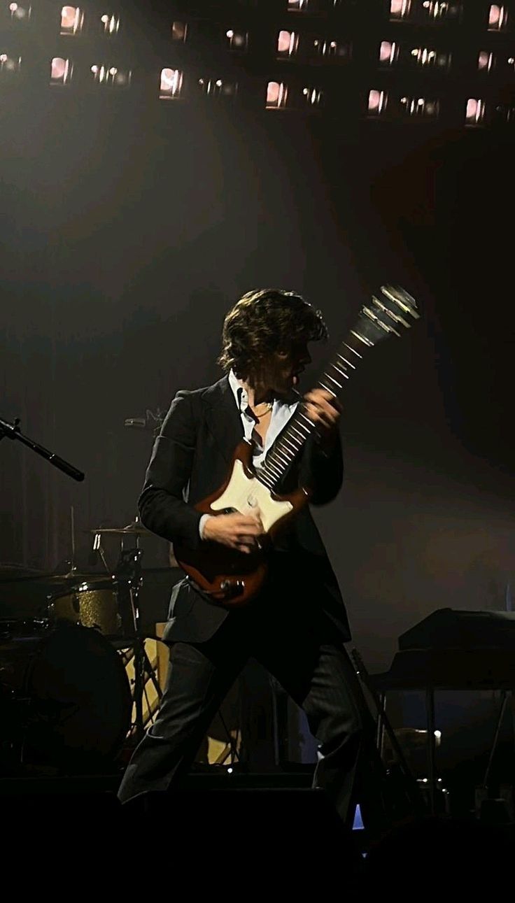 a man playing an electric guitar on stage