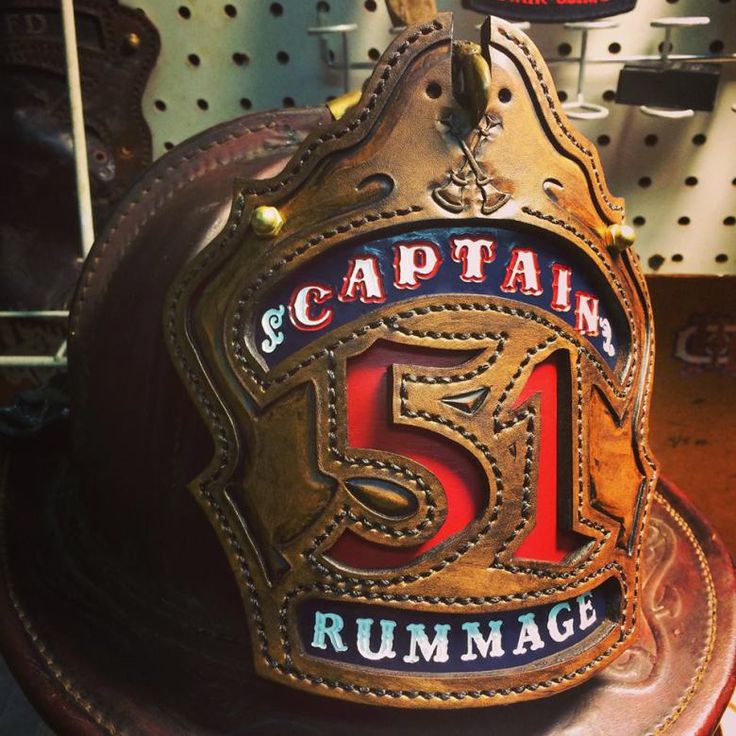 a fireman's hat with the number 51 on it is sitting on a table