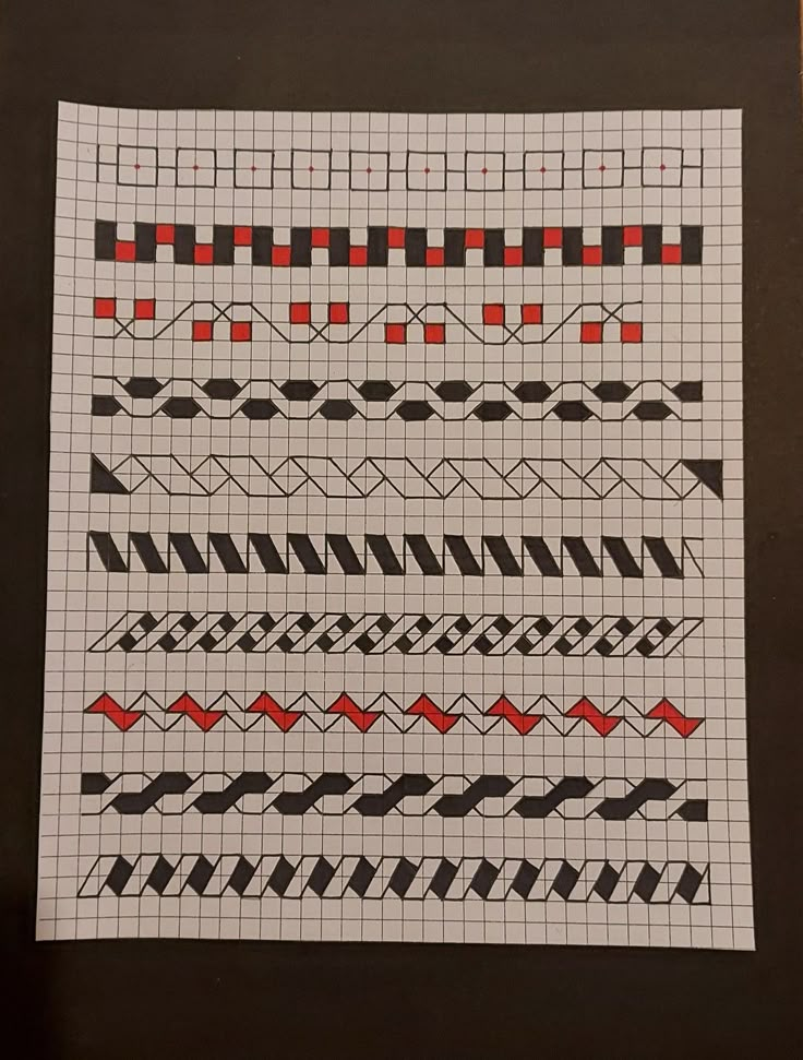 a piece of paper that has some type of pattern on it with red and black lines