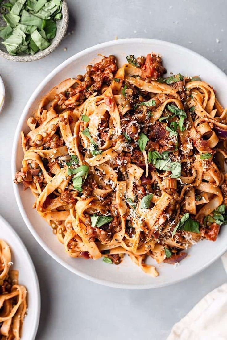 a white plate topped with pasta covered in sauce