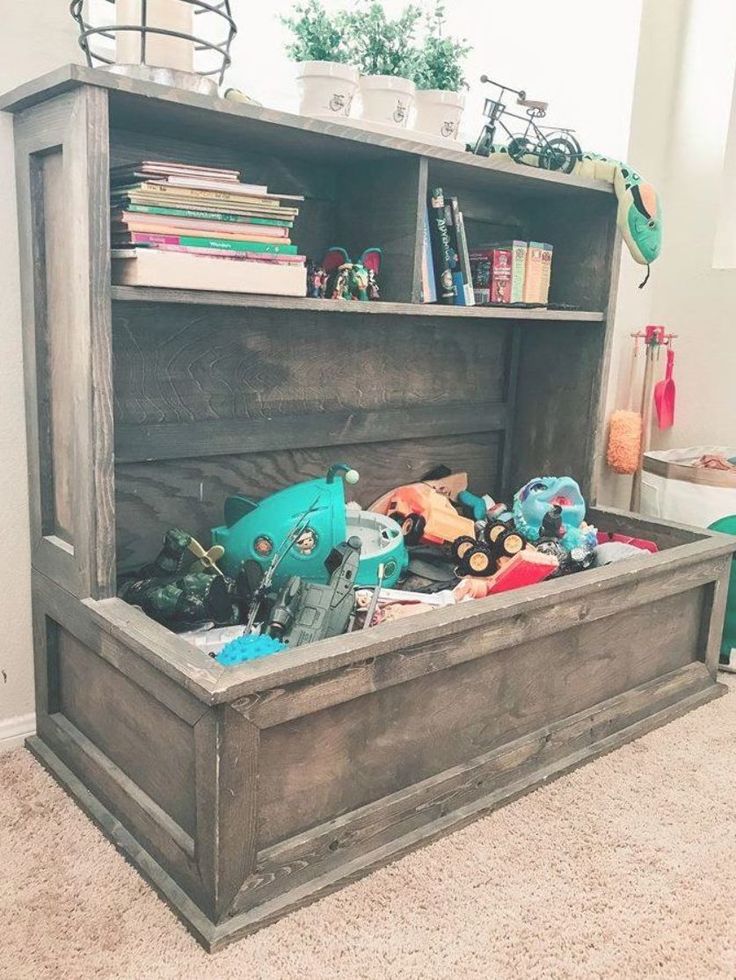 an old wooden toy chest with toys in it