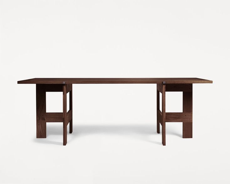 a wooden table sitting on top of a white floor