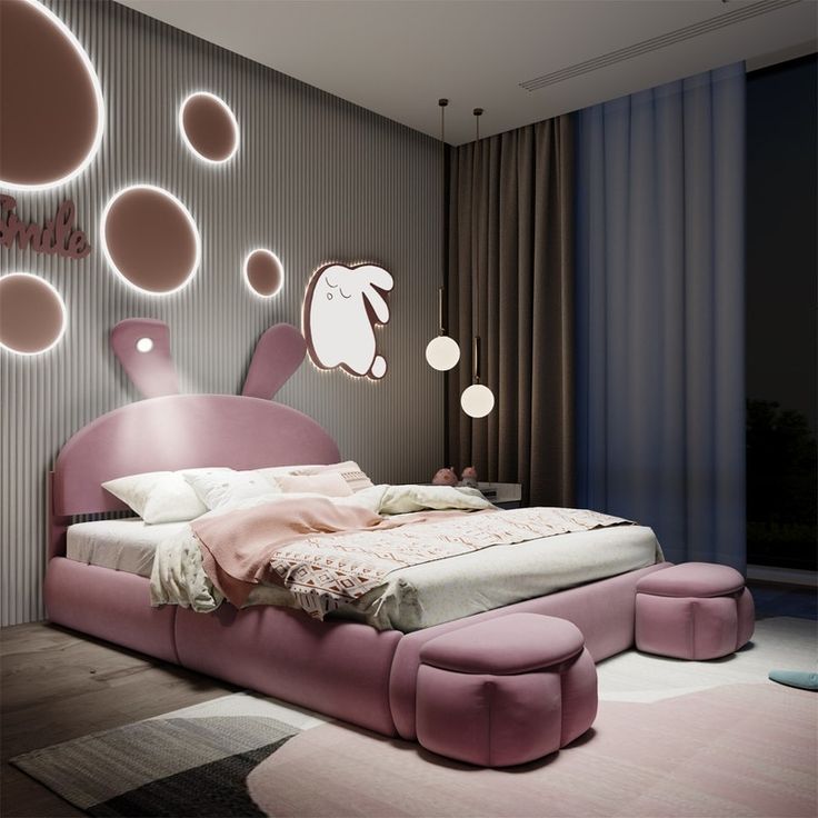 a pink bed sitting in the middle of a bedroom next to a wall with circles on it