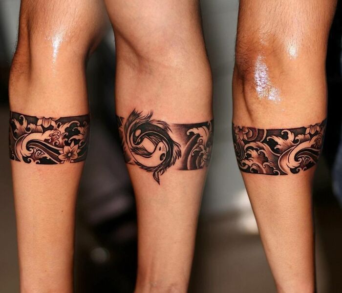 two people with tattoos on their legs