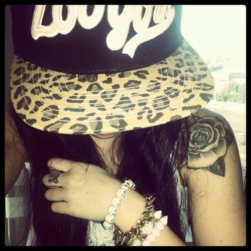 a woman wearing a leopard print hat and bracelets