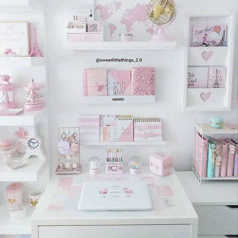 a white desk topped with lots of shelves filled with pink and white items on top of it