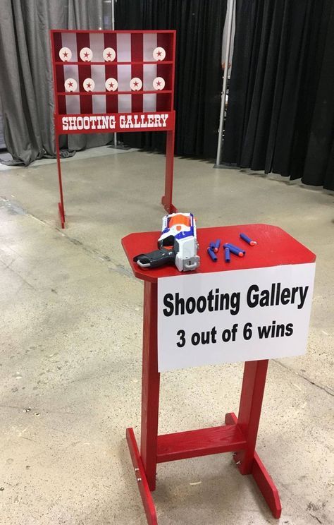 a red table with a sign that says shooting gallery 3 out of 6 win's